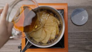 Tofu in pot and adding marinade