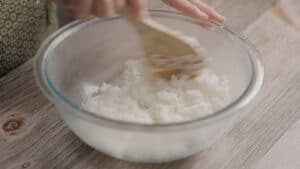 Mixing sushi rice in a bowl