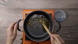 Stirring oil and garlic in pot