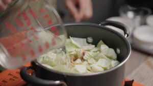 Pouring water into pot of cabbage